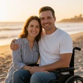 A 31-year-old white man in a wheelchair with his partner at a beach sunset, an OpenHeartMatch success story